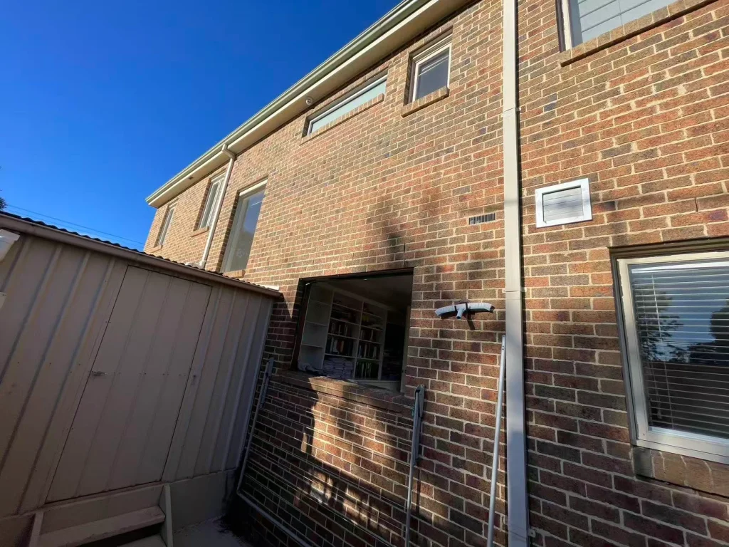 Upper-floor windows in the brick facade