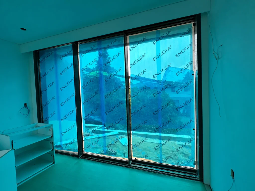 Wide sliding glazing seen from an unfinished interior