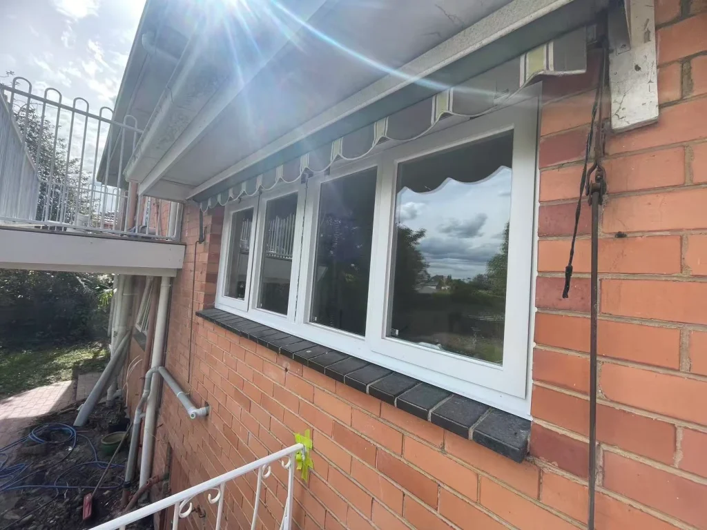 New white-framed windows below the existing awning